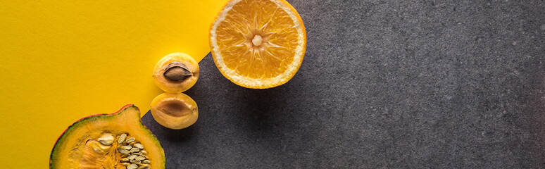 top view of pumpkin, orange and apricot on yellow and grey background, panoramic shot