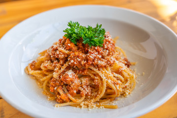Tasty minced beef spaghetti decorated with parsley on top 