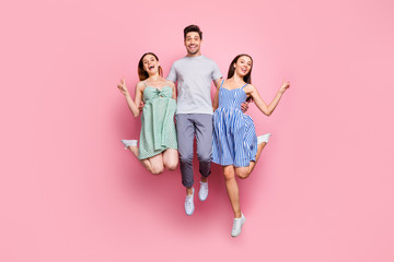 Full body photo of active people wearing striped t-shirt dress skirt making v-signs isolated over pink background