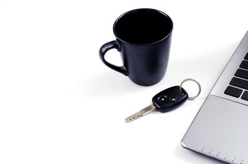 Obraz na płótnie Canvas Black coffee cups and Car key and labtop computer on white backgrounds for minimalist style concept