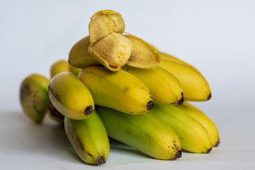 A bunch of small ripe bananas, front view, on white background