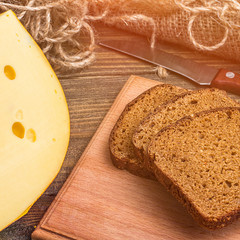 Cheese wheel on wooden background.Vegetarian food