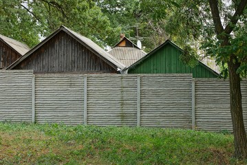 long private concrete gray fence on a rural street