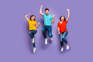 Full length size body photo of three crazy funky carefree buddies teamwork company raising fists up...