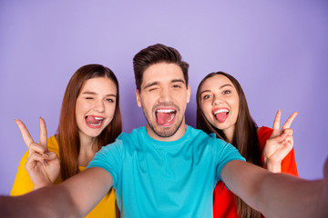 Closeup photo portrait of one comic winking brunet and two cute beautiful blinking girlfriends...