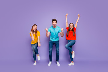 Full length size body photo of cheerful enthusiastic positive mad having fun triumph and luck three glad people gesturing hands raising fists up isolated violet background