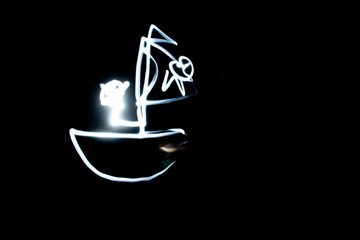 Freezelight. Drawing light in the dark. Round scribbles at night.