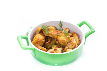 chicken fried in batter with dill on a plate