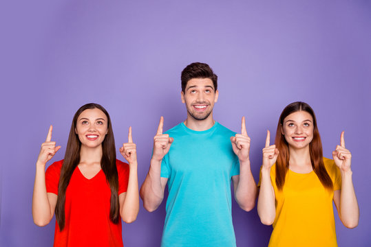Close-up photo portrait of three people one boy and two beautiful ladies want you to pay attention on copyspace over heads isolated violet background