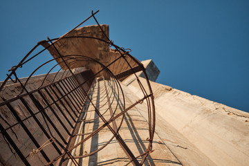 damaged old tower with iron stairs archeological architecture industrial.