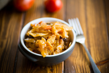 Stewed cabbage on the old wooden background