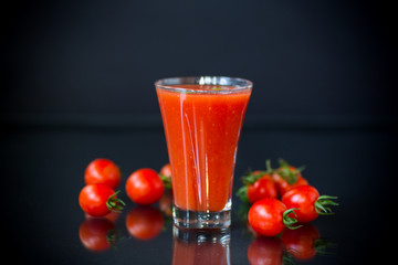 homemade tomato juice in a glass and fresh tomatoes