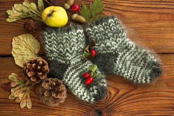 Hygge flatlay. Woolen socks on a wooden background top view with copy space.