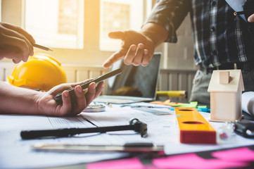 Engineer is advising the contractor on the wiring in the building.