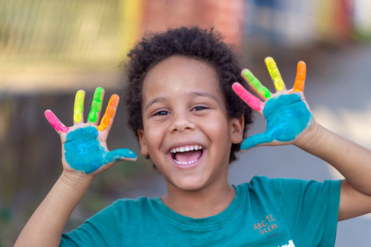 Naklejki beautiful happy boy with painted hands