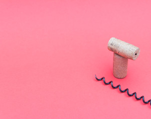 Wine corks with corkscrew on red background. Free copy space.