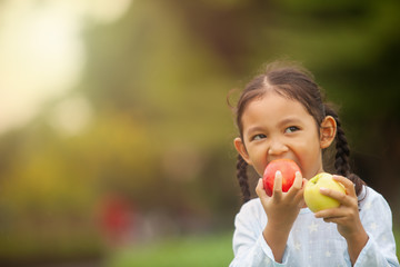 child eating apple little girl playing peek a boo holding fresh ripe apples