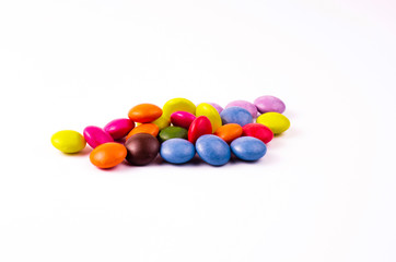 Chocolates with a multi-colored coating on a white background