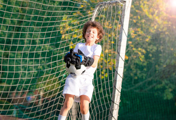 Summer soccer tournament for young kids. emotions and joy of the game. Young goalie. Boy goalkeeper in football sportswear on stadium. Happy boy football player after goal scored