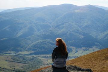 Girl with red hair. Beautiful sweater. Mountain trip. Carpathian Mountains hair