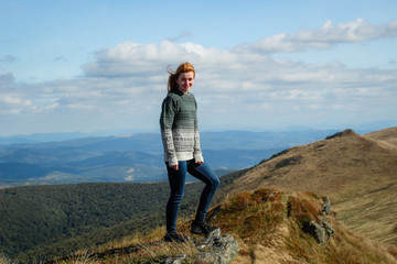 Girl with red hair. Beautiful sweater. Mountain trip. Carpathian Mountains hair