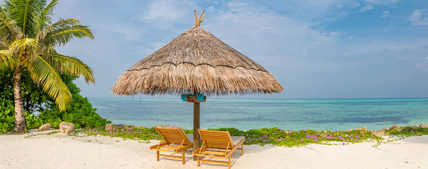 Chairs and umbrella in beach. Tropical holiday banner