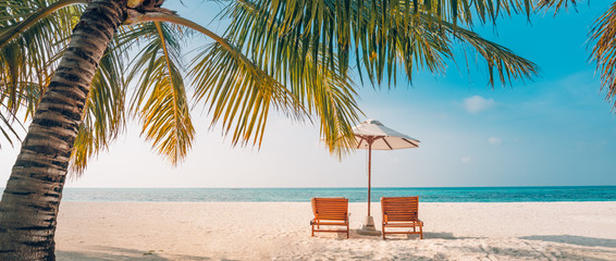 Beautiful Maldives island beach landscape. Luxury resort with chairs and umbrella for summer...