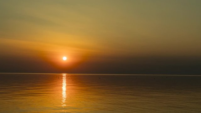Time lapse shot of a beautiful sunset over the North Sea as seen from B&uuml;sum, Germany, on a calm and almost cloudless summer evening.