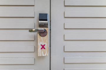 Door of hotel room with sign please do not disturb - retro style
