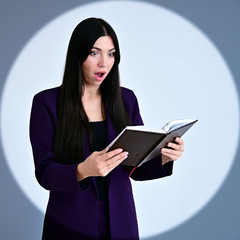 Portrait of a pretty brunette girl with long hair manager in a dark business suit in a circle of...