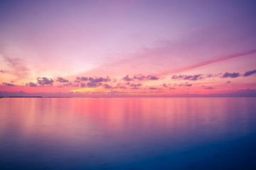 Zen sea sky sunset. Perfect sunset seascape. Vivid twilight sunset sky and motion blur of the sea under with long exposure effect.