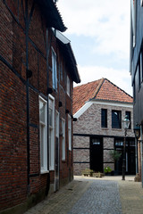 Fototapeta na wymiar View through alley in historic Dutch city Ootmarsem, Overijssel, Netherlands