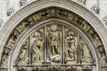 Fototapeta na wymiar Medieval statues on historical facade of City Hall on Grand Place in Brussels, Belgium