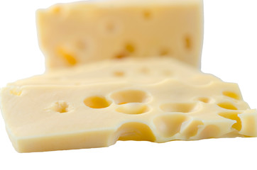 Slices of hard cheese on white background