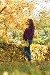 Portrait of beautiful young woman posing in autumn park