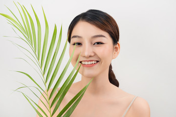 Fototapeta premium Beautiful woman of Asian appearance palm leaf nature skin care