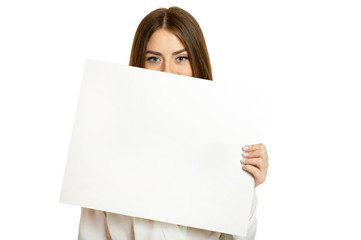 Beautiful woman and white signboard ard or copyspace for slogan or text, isolated