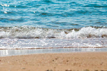 sandy beach and blue sea wave. Beautiful natural background. Tourism and travel.