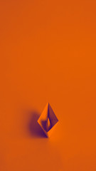 Burnt orange paper boat on a burnt orange background. A poster for a gynecologist's office....