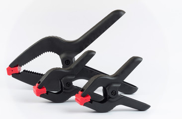 Large and two small plastic clamps on a white background