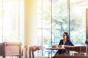 Summertime at work. Business lady drinking coffee in the office. Copy space on the left side