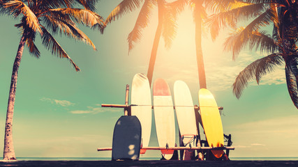 Surfboard and palm tree on beach background. - obrazy, fototapety, plakaty