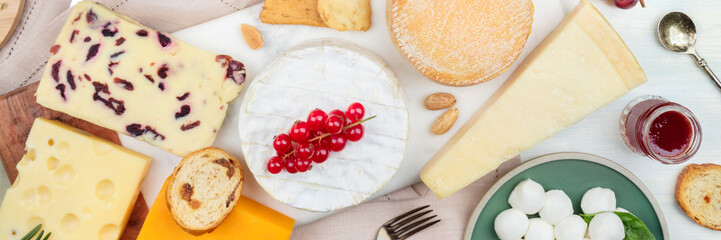 A panorama of cheeses, shot from the top. Cheese platter flat lay.