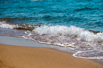 sandy beach and blue sea wave. Beautiful natural background. Tourism and travel.