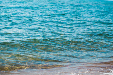 sandy beach and blue sea wave. Beautiful natural background. Tourism and travel.