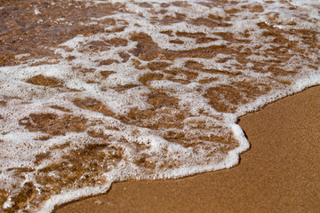 sandy beach and blue sea wave. Beautiful natural background. Tourism and travel.
