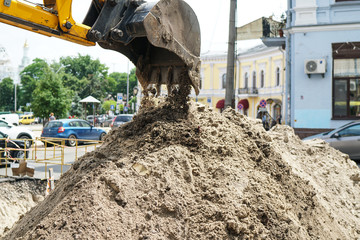 construction machinery at the construction site of the road in the quarry is gaining ground and...