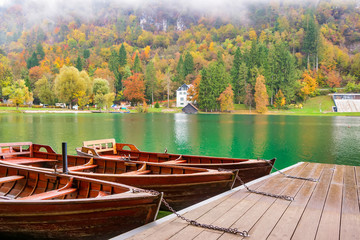 Autumn scenery with boats moored on Bled lake, Slovenia