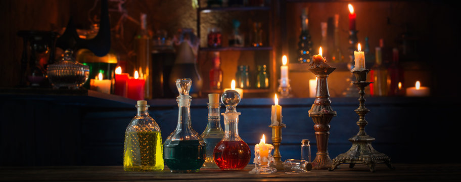 magic potions in bottles on wooden background