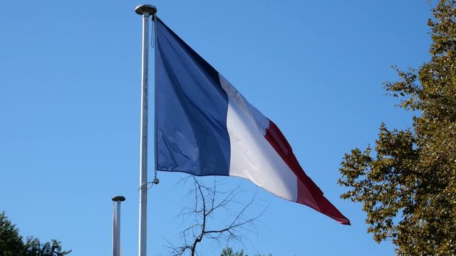 french flag with blue sky in the background